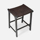 Stool with woven seat and black frame on a white background