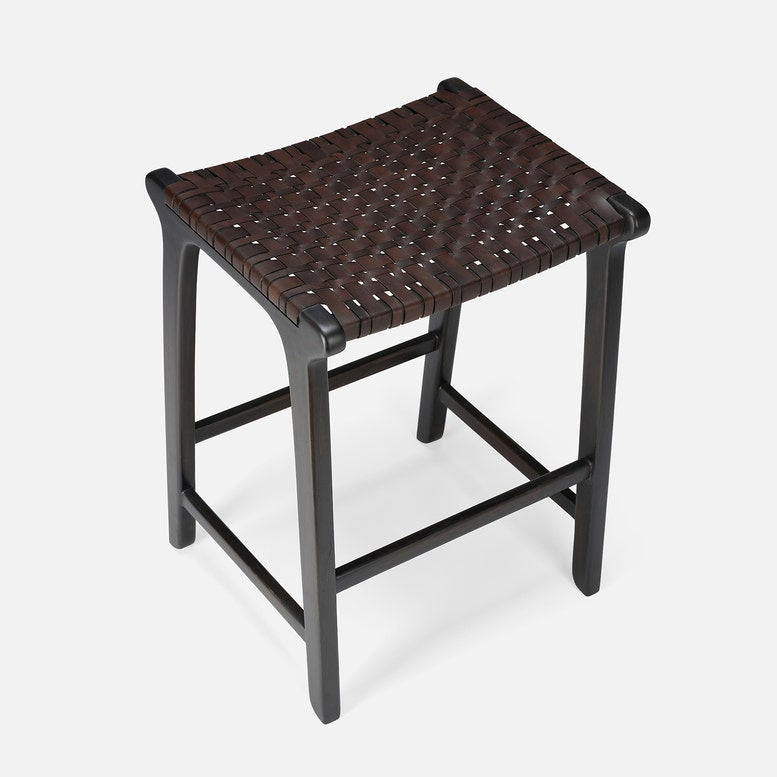 Stool with woven seat and black frame on a white background