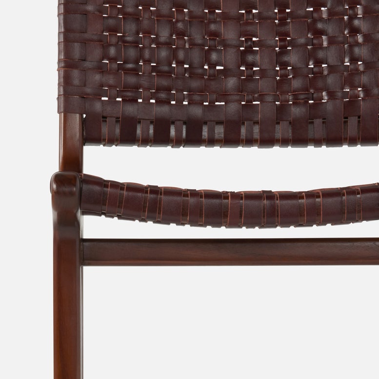 Close-up of a brown woven chair with a white background
