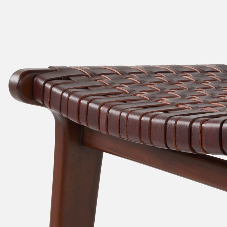Close-up of a brown woven chair seat on a white background