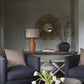 Modern living room with dark gray chairs, a wooden console table, and decorative items.