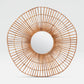 Round rattan mirror with a white center on a light gray background