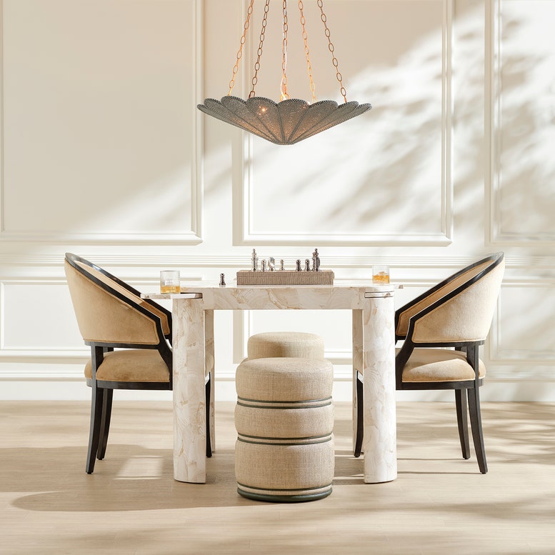 steel and coco beads chandelier hanging over a game table and chairs