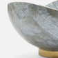 Decorative bowl with a cracked texture and gold base on a white background