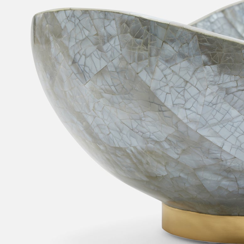 Decorative bowl with a cracked texture and gold base on a white background