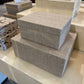 Stack of textured storage boxes on a counter