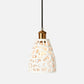 Pendant light with a decorative white shade on a white background