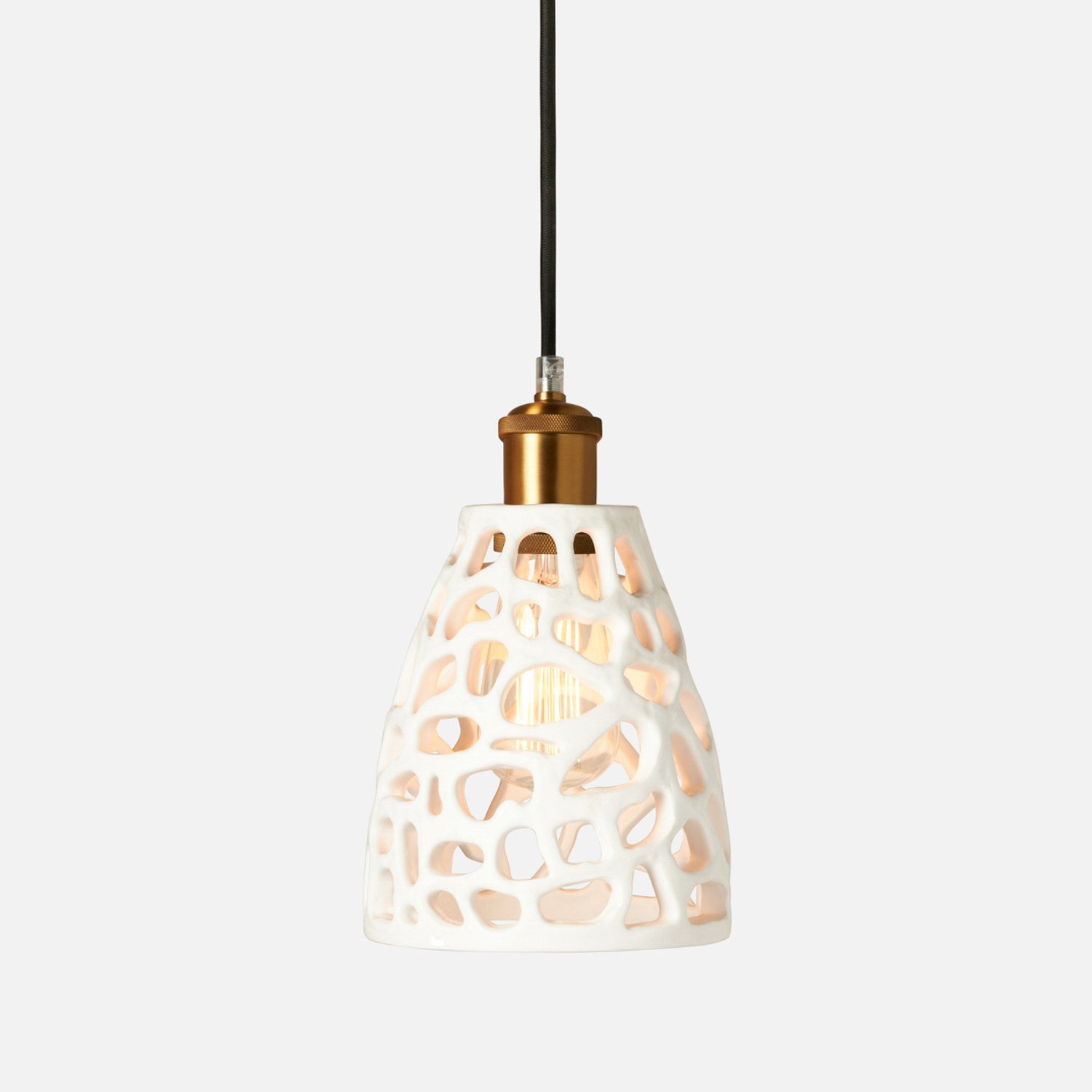 Pendant light with a decorative white shade on a white background