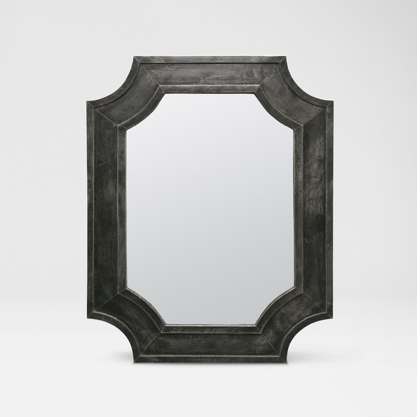 Rectangular mirror with a dark, textured frame on a light gray background