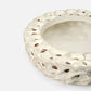 Decorative ceramic bowl with textured edge on a white background