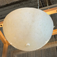 Round concrete-like object on a textured surface