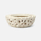 Decorative white ceramic planter with intricate cut-out design on a white background