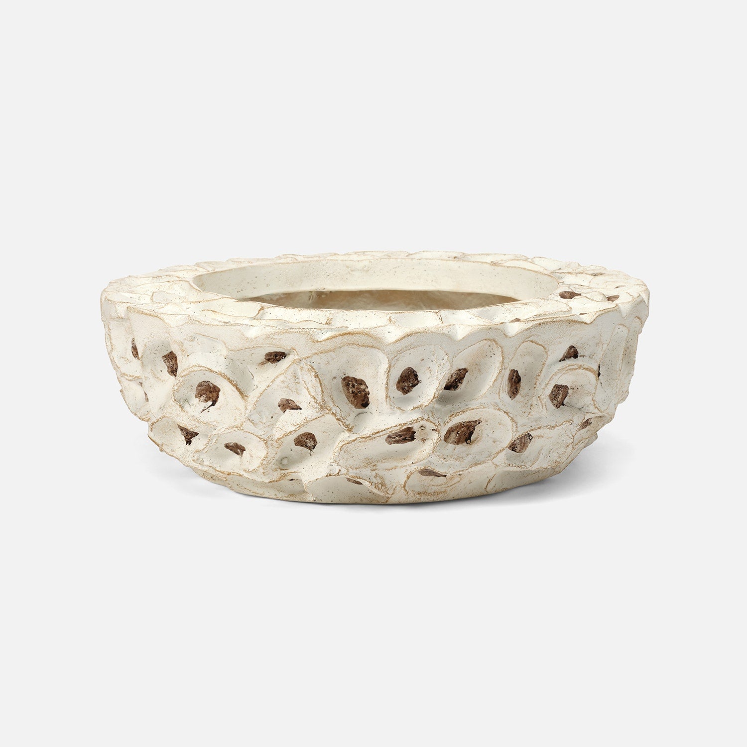 Decorative white ceramic planter with intricate cut-out design on a white background