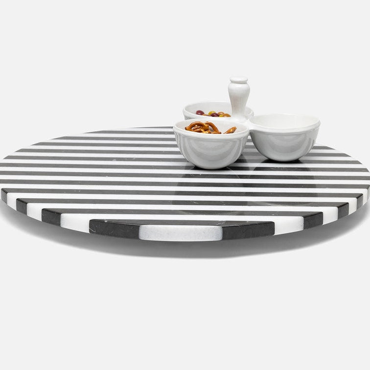 Round black and white striped tray with small bowls on a white background