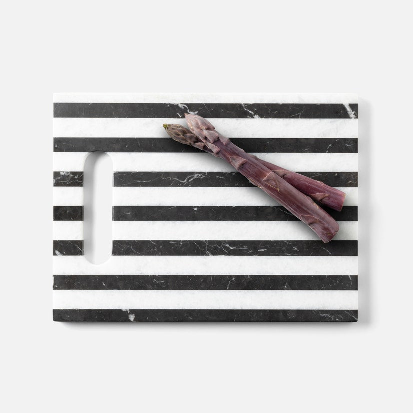 Asparagus on a black and white striped marble surface