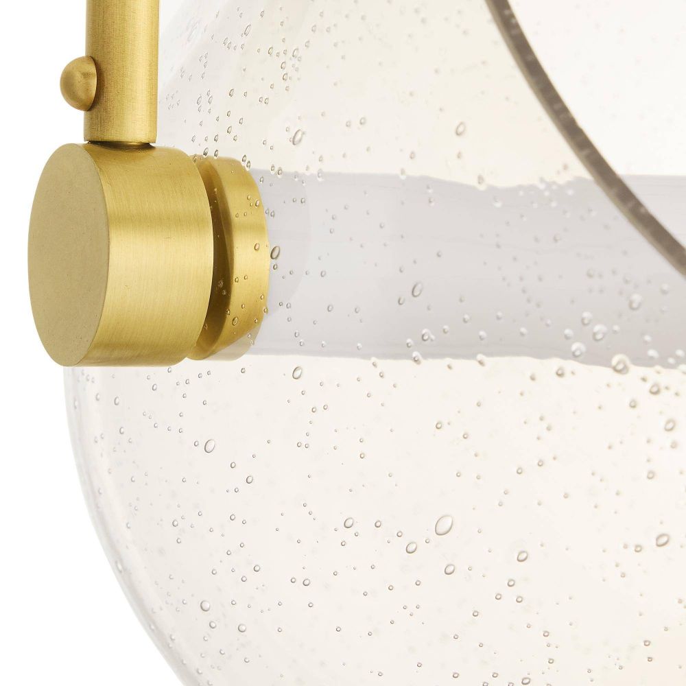 Close-up of a gold shower head with water droplets on a white background