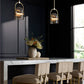 Modern dining room with marble table, beige chairs, and pendant lights.