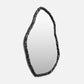 Decorative mirror with a black, textured frame on a white background