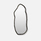 Decorative mirror with a unique, organic frame on a white background