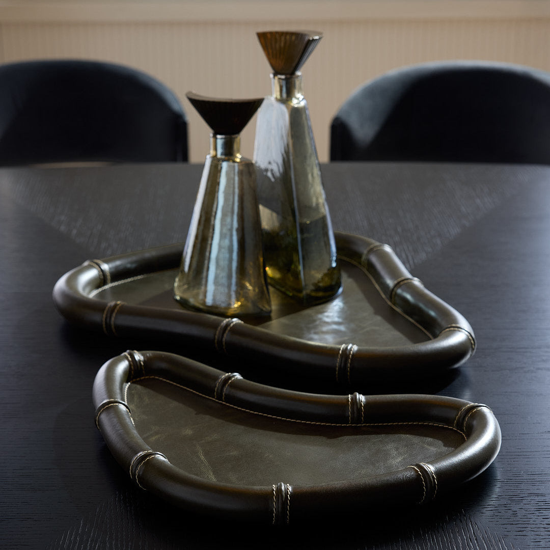 Decorative ceramic items on a dark surface with a neutral background