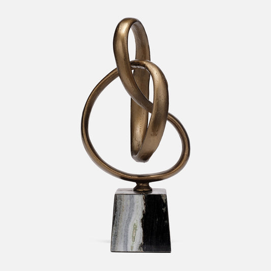 Bronze sculpture of intertwined rings on a marble base against a white background