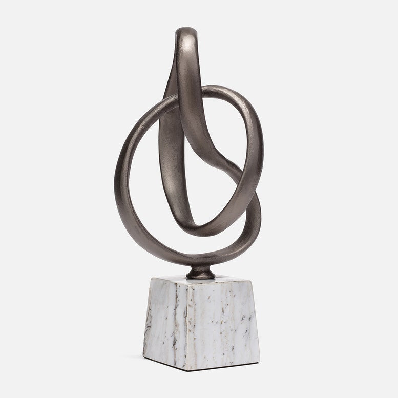 Abstract metal sculpture with interlocking rings on a white background