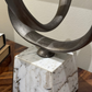 Decorative sculpture with circular design on a marble base