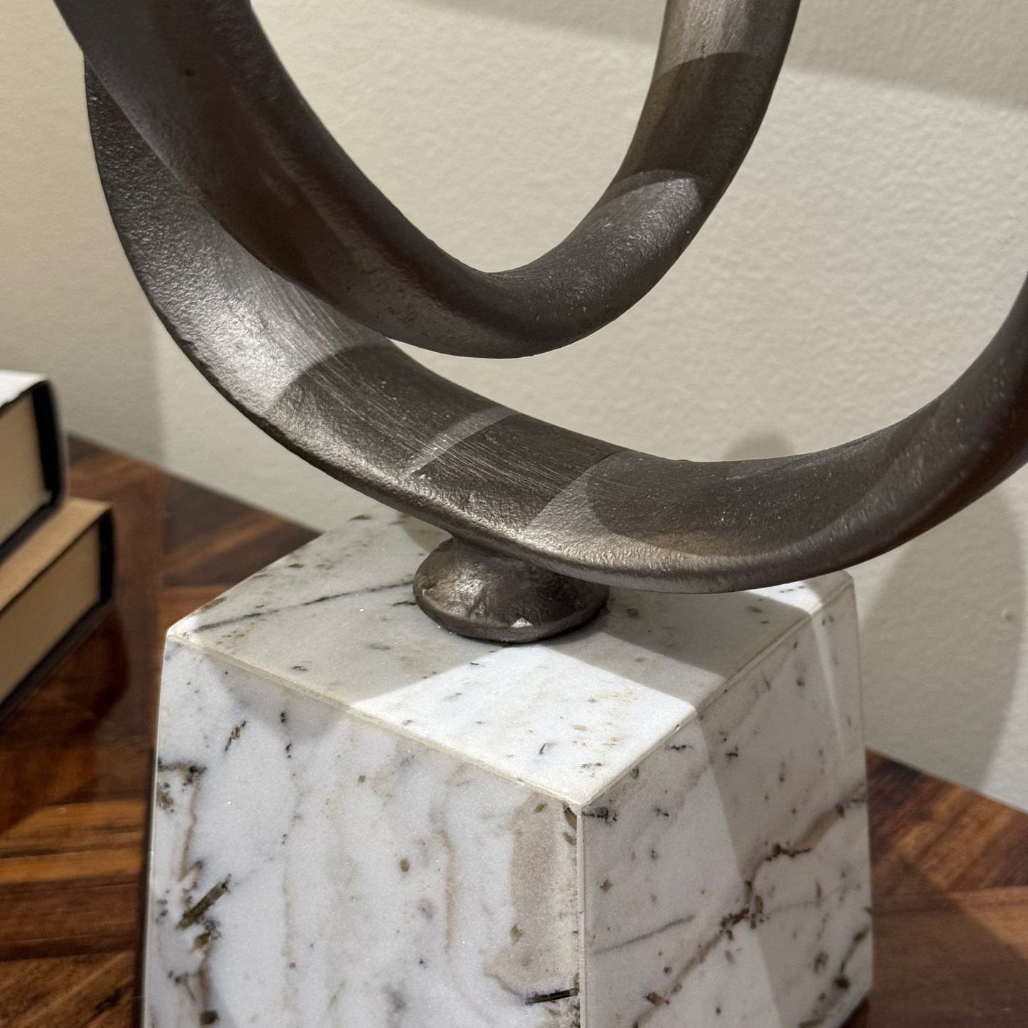 Decorative sculpture with circular design on a marble base