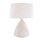 White table lamp with a textured base on a white background