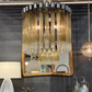 Modern interior design with a mirror, lamp, and decorative items against a dark wall.