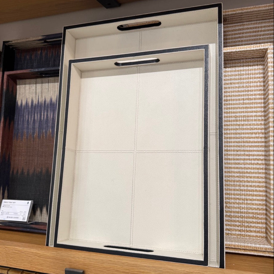 Framed artwork displayed on a wall with other decorative items.