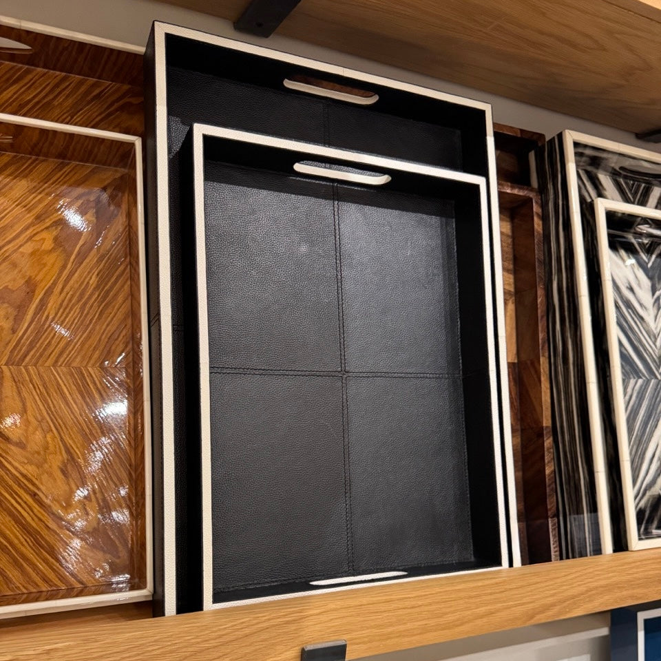 Collection of framed artworks on a wooden shelf