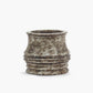Decorative pot with textured surface on a white background