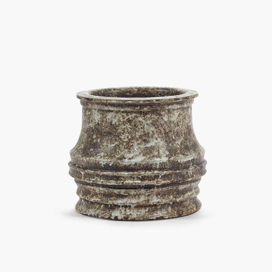 Decorative pot with textured surface on a white background