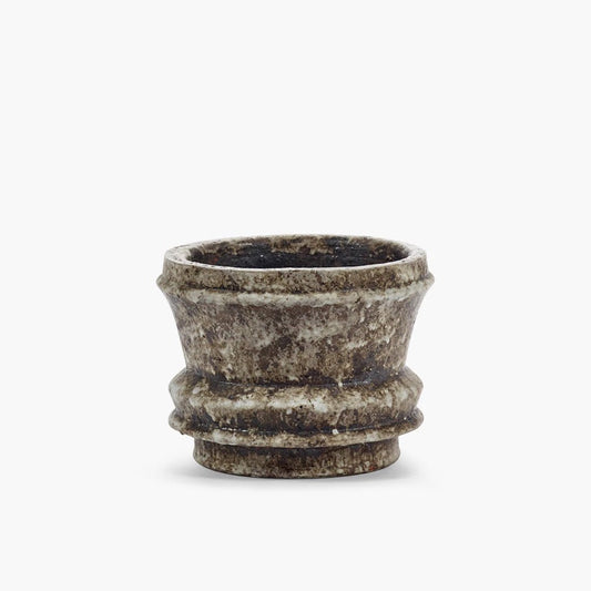 Decorative ceramic pot with textured surface on a white background