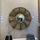 Round woven mirror on a wall with other decorative items