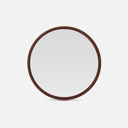 Round mirror with a leather frame on a white background