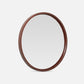 Round mirror with a leather frame on a white background