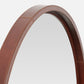 Round mirror with a brown leather frame on a white background