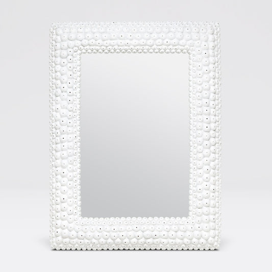 Mirror with a decorative white bead frame on a light gray background