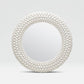 Round mirror with a white bead frame on a light gray background