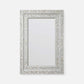 A rectangular wall mirror with an ornate silver-toned frame made of inlay mosaic pieces, shown against a plain light gray background.