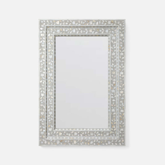 A rectangular wall mirror with an ornate silver-toned frame made of inlay mosaic pieces, shown against a plain light gray background.