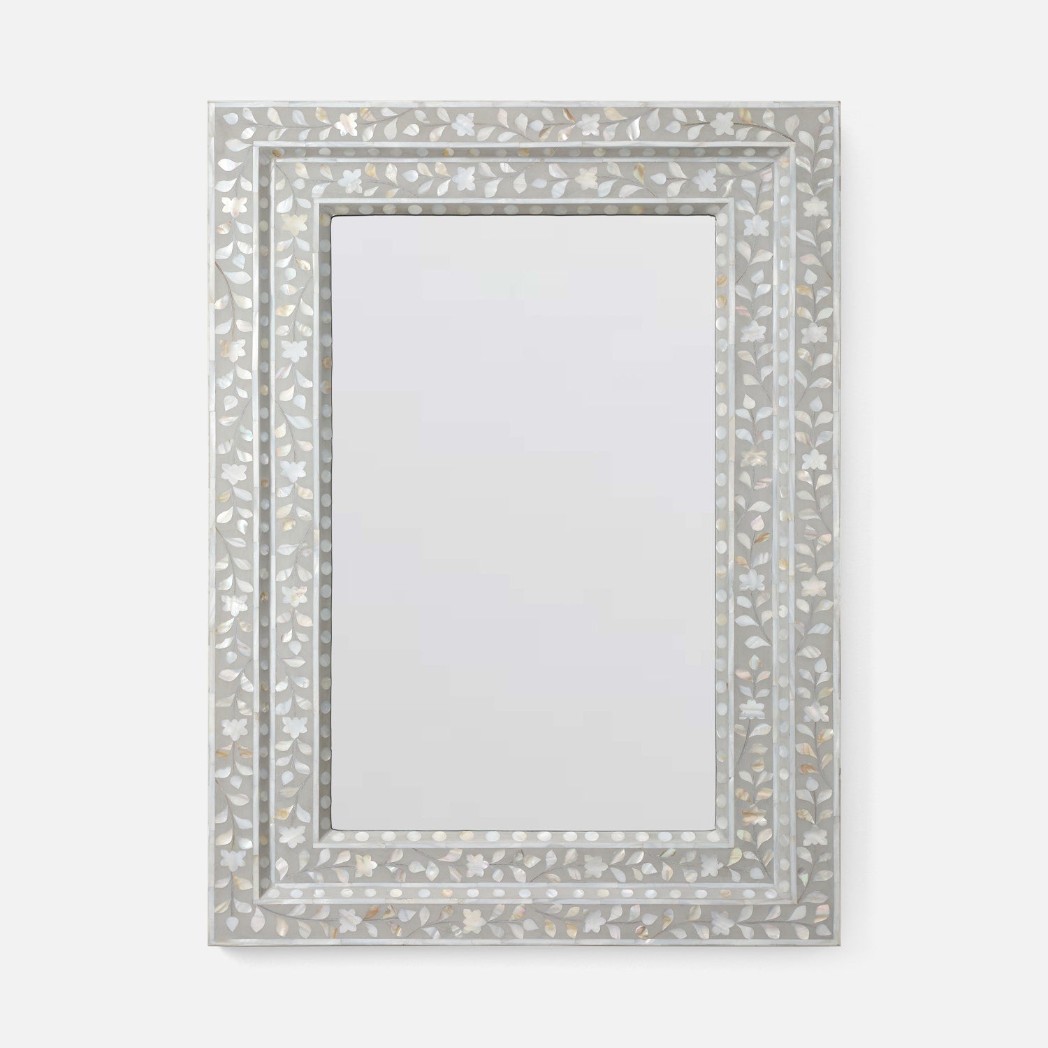 A rectangular wall mirror with an ornate silver frame made of inlay mosaic shell-like pieces in a leaf pattern, shown against a plain light gray background.