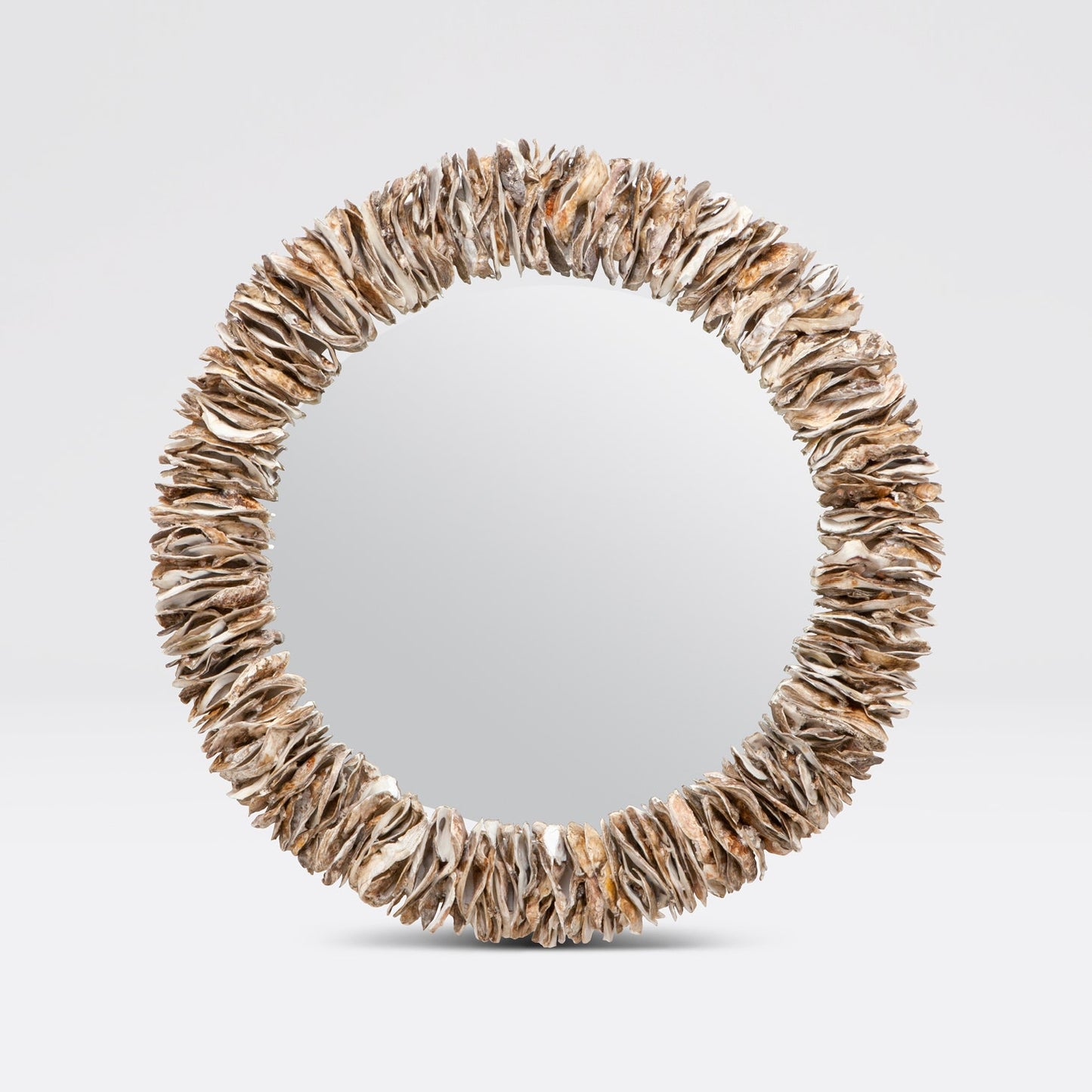 Round mirror with a natural, organic frame on a light gray background