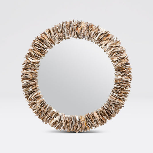 Round mirror with a natural, organic frame on a light gray background