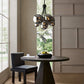 Modern dining room with a round table, chair, and decorative chandelier.