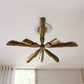 Vintage-style ceiling fan with brass finish on a white ceiling