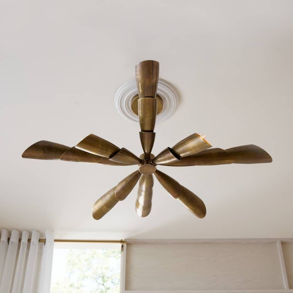 Vintage-style ceiling fan with brass finish on a white ceiling