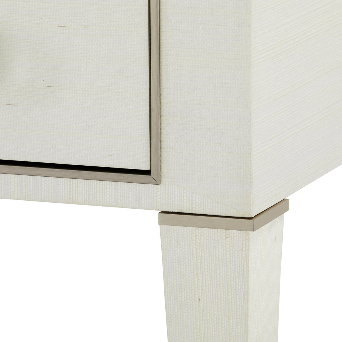 Close-up of a piece of furniture with a textured surface and metallic trim.